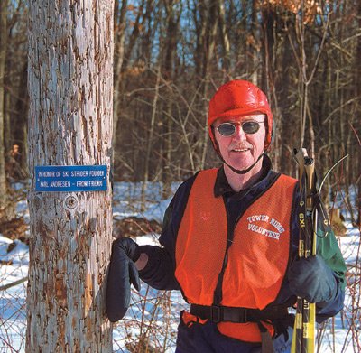 Andresen poses next to a light pole sponsored by friends in his honor at the Tower Ridge Trail in Eau Claire,WI.