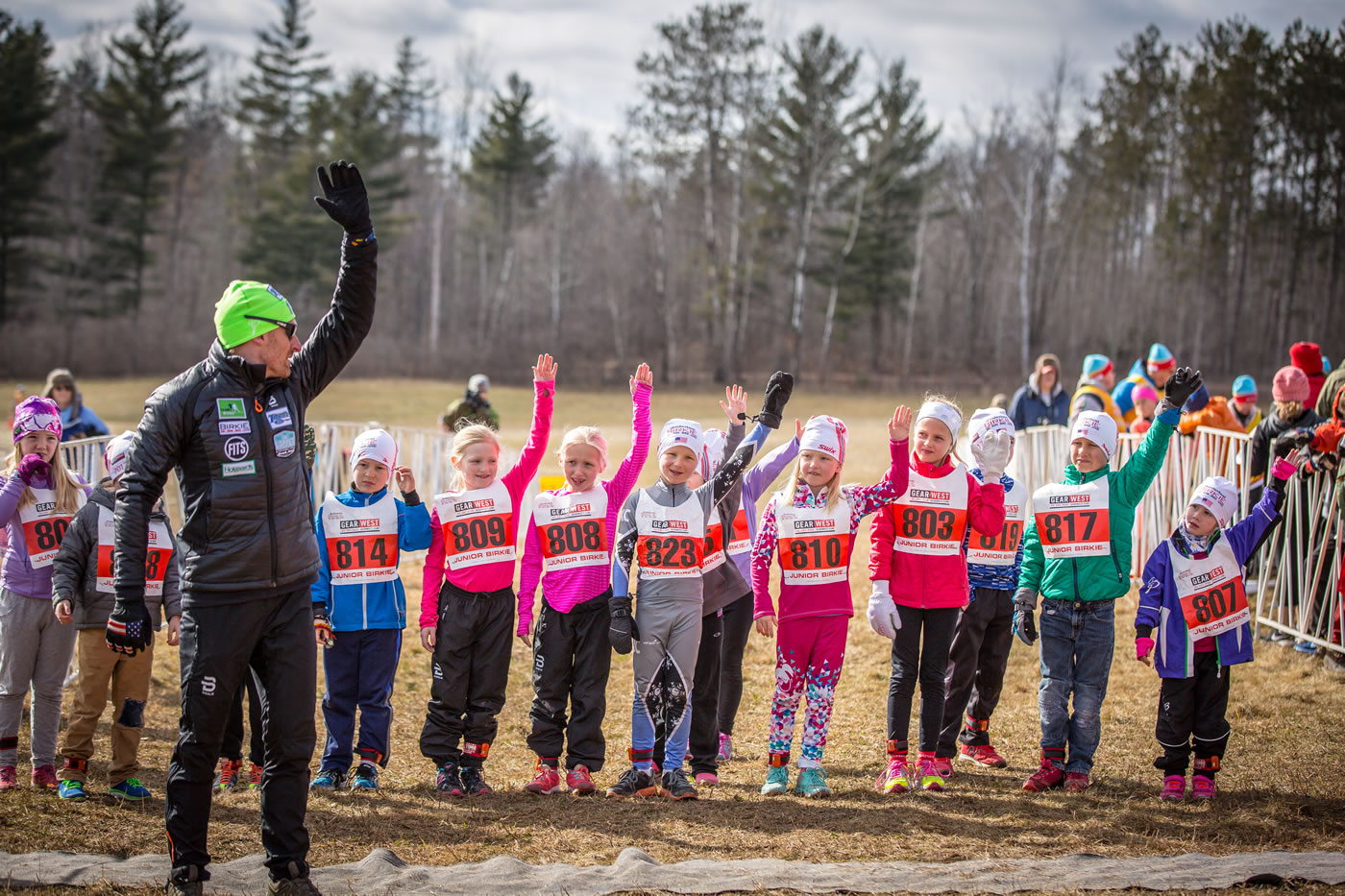 Brian Gregg of Team Gregg leading warm-ups before the Junior and BarneBirkie running races. Not much snow but lots of enthusiastic kids! [Photo] Courtesy of ©American Birkebeiner Ski Foundation. [Photo] Courtesy of ©American Birkebeiner Ski Foundation